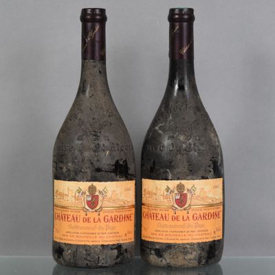 two bottles of wine sitting on top of a table next to each other