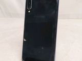 the back of a black samsung phone sitting on top of a table