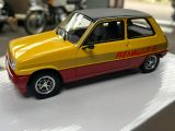 yellow and red toy car sitting on top of a white table