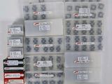 many boxes of screws and nuts on a white surface