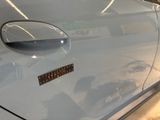 a close up of a car door with a sticker on it