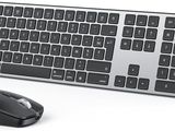 a computer keyboard and a mouse on a white surface