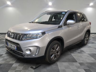 the silver suzuki suv is parked on a checkered floor