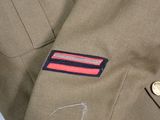 a close up of a military uniform with a badge on it