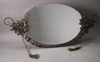 a mirror with flowers on it sitting on a table