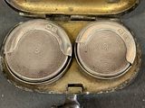 a silver case that has two silver plates inside of it