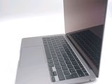 a silver laptop computer sitting on top of a white table