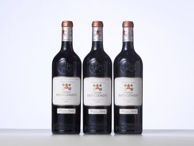 trois bouteilles de vin posées sur une table l'une à côté de l'autre