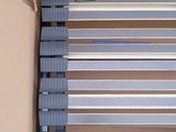 a cardboard box with a blue and white striped bench inside of it
