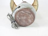 a small metal object with a cord attached to it