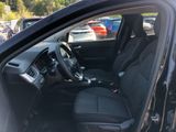 the interior of a car with black seats and a steering wheel