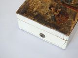 a white box with a painting on it on a table