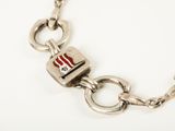 silver bracelet with a red and white flag charm on a chain