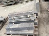 many pieces of marble on a pallet in a warehouse