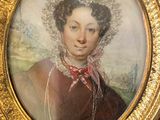 portrait of a woman in a red dress and bonnet in a gold frame