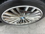 tire of a car with a sticker on the rim of it