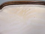 a close up of a white chair with a wood frame