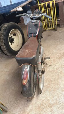 a motorcycle that is parked in a garage next to a truck