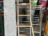 a stack of buckets and a ladder in a garage