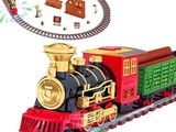 a toy train that is on the tracks with a christmas tree in the background