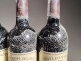 three bottles of wine sitting on top of a table next to each other