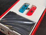 two nintendo wii controllers in a red box on a table