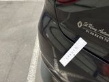a sticker on the back of a car that is parked in a parking lot