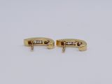 pair of yellow gold and diamond earrings on a white background