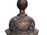 a blue and red vase sitting on a white surface