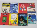 plusieurs livres pour enfants sont alignés sur une surface blanche