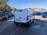 the back of a white van parked in a parking lot