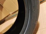 the tire of a motorcycle is sitting on the floor next to a cardboard box