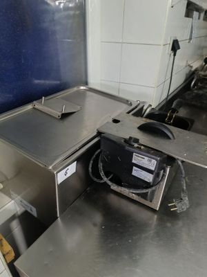 stainless steel counter top in a commercial kitchen with a microwave on it