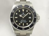 a rolex watch with a black dial on a bracelet