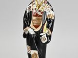 figurine of a woman dressed in a kimono suit and hat