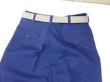 a pair of blue pants with a belt on a white surface