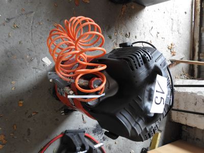 a black and orange blower sitting next to a window