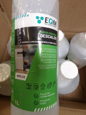 a bottle of liquid sitting on top of a cardboard box