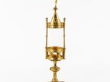 an image of a gold cup with a cross on top of it
