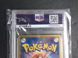 the pokemon card is in a plastic case on a table
