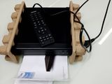 a laptop computer sitting on top of a wooden stand