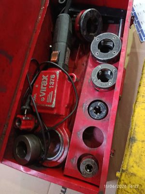 a red tool box with tools in it sitting on the floor