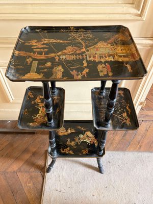 a black table with three trays on top of it