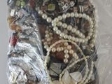 a bag of assorted beads and jewelry in it