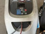 a machine that is sitting on the ground in the garage