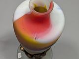 a vase with a red, yellow, and white design on it