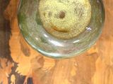 a glass vase on a table with a flower pattern