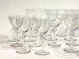 many empty wine glasses lined up on a table