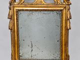an image of a gold framed mirror with a bird on it