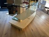 a glass table with a glass top on a hard wood floor